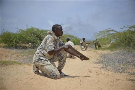 A soldier from the Somali National Army uses a belt acting as a weapon during a training exercise in Mogadishu