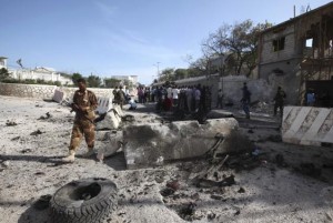 A Somali government soldier secures the scene of a suicide attack next to the gate of the Presidential Palace in Mogadishu