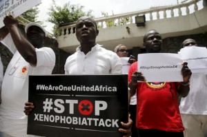 People protesting against xenophobia in South Africa hold placards in front of the South African consulate in Lagos