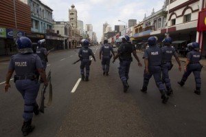 Police clear the streets in an attempt to quell rioting and looting caused from anti-foreigner violence in Durban