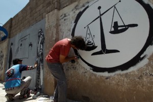 Yemeni artists finish graffitis against corruption in Yemen on a wall in the capital Sanaa on June 5, 2014. AFP PHOTO / MOHAMMED HUWAIS        (Photo credit should read MOHAMMED HUWAIS/AFP/Getty Images)