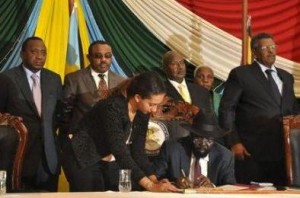 South Sudan's President Salva Kiir (seated) signs a peace agreement in South Sudan's capital Juba, August 26, 2015. REUTERS/Jok Solomun