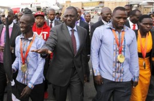 Kenya's Deputy President William Ruto (C) welcomes the national athletics team at the Jomo Kenyatta airport in Nairobi, September 1, 2015, after they topped the medals table at the recently concluded 15th International Association of Athletics Federations (IAAF) World Championships at the National Stadium in Beijing, China. With him are (L-R) gold medallists Ezekiel Kemboi of men's 3000 metres steeplechase, Julius Yego of men's javelin and silver medallist Helal Kiprop of women's marathon. REUTERS/Thomas Mukoya - RTX1QJ8X