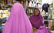 In this Tuesday, Jan. 26, 2016 photo, Shukri Abasheikh, owner of Mogadishu Store, speaks with a customer in Lewiston, Maine. "When Somalis came in, Lewiston people, Maine people, they think they need welfare but we don't need welfare. We need jobs. We need peace. We need education," said Abasheikh, who worked as a janitor before achieving her dream of running her own business. (AP Photo/Robert F. Bukaty)