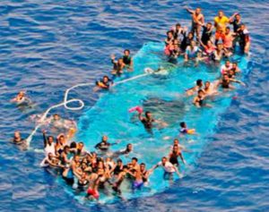Migrants are seen on a partially submerged boat before to be rescued by Spanish fregate Reina Sofia (unseen) taking part in the European Union military operation in the Southern Central Mediterranean (EUNAVFOR MED) off the coast of Libya in this handout picture courtesy of the EUNAFVOR MED released on May 26, 2016. EUNAVFOR MED/Handout via REUTERS