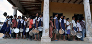 Indian schoolchildren wait in line for their mid-day meal at a government primary school in the outskirts of Hyderabad on June 13, 2011, on the opening day of the new academic year. The government of India's Andhra Pradesh state has introduced English as a second language from Class 1 onwards for the 2011-2012 academic year. India's National Knowledge Commission has admitted that no more than one percent of country's population uses English as a second language. AFP PHOTO/Noah SEELAM (Photo credit should read NOAH SEELAM/AFP/Getty Images)